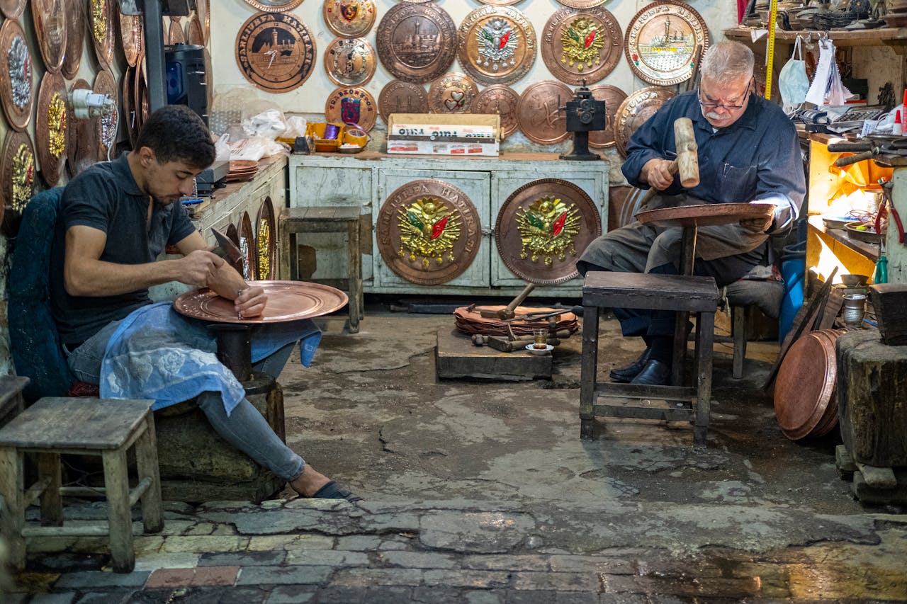 Artisans Sitting in a Workshop and Working on Cooper, Patterned Trays